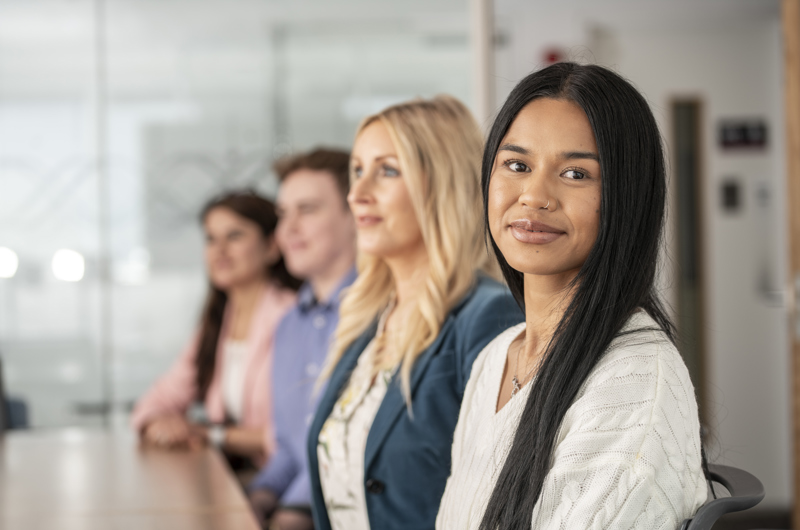 Group of employees sitting in a line